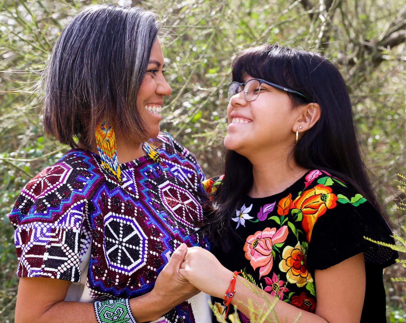 Mother and autistic teen daughter smiling at each other