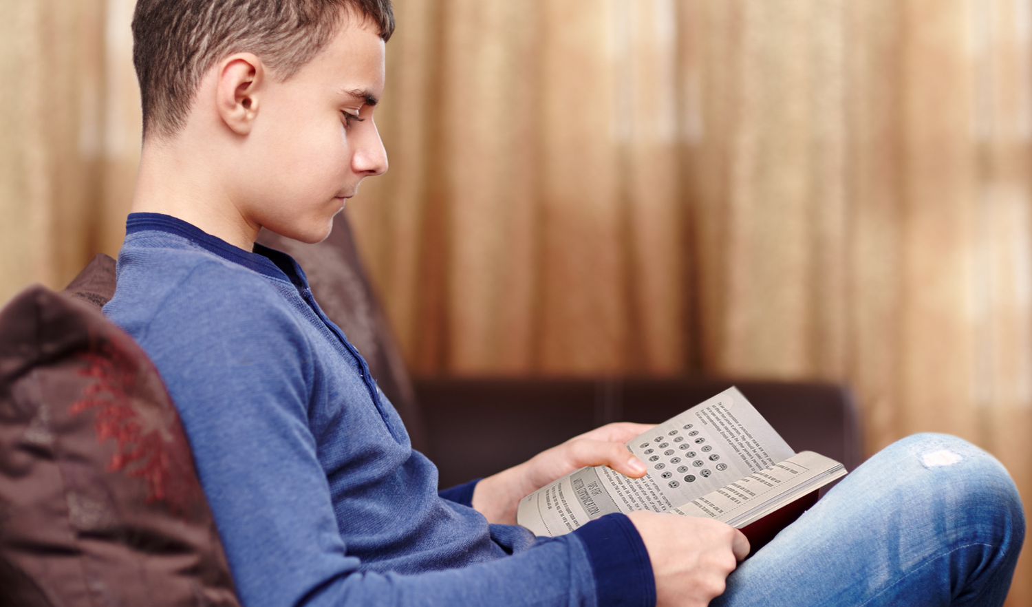 Boy reading being autistic and a teenager book